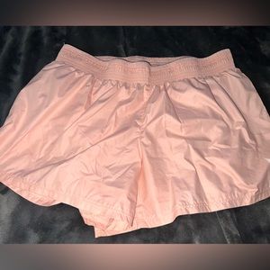 Baby pink Nike running shorts